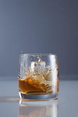 splash of whiskey with ice