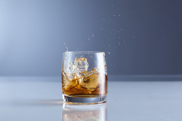 splash of whiskey with ice