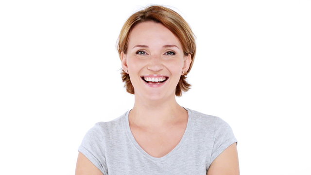 Beautiful happy surprised woman with positive emotions over white background