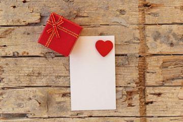 Love heart on notebook on wooden table and gift box