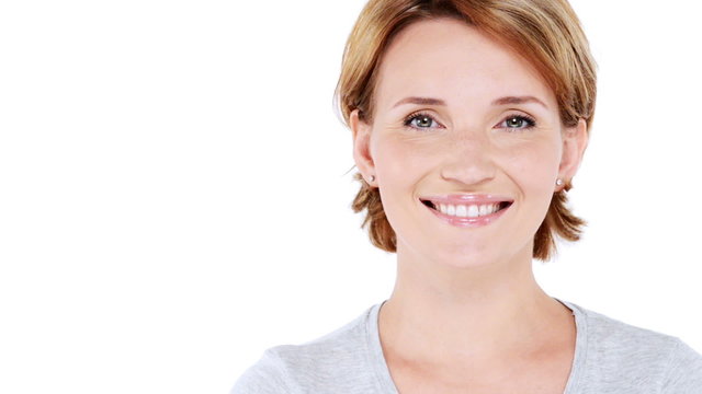 Front  portrait of the beautiful  smiling woman looking at camera over white background