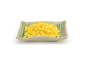 Hulled-split monk bean in small square ceramic bowl isolated on white