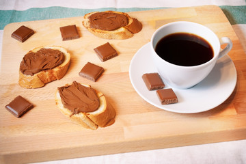 Toasts with chocolate spread and cup of coffee