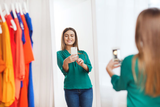 Woman With Smartphone Taking Mirror Selfie At Home