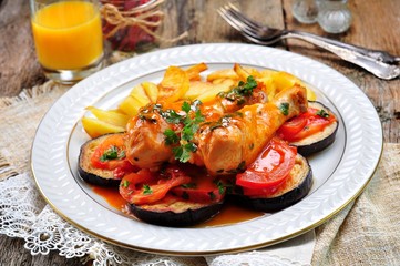 Braised chicken in white wine with eggplant, tomato and french fries.