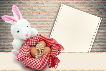 White rabbit with eggs on brick background