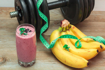 smoothies and a bunch of bananas, a dumbbell in the background