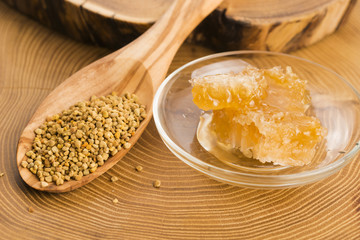 Fresh bee pollen in the spoon with honeycomb