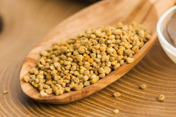 Fresh bee pollen in the spoon with honeycomb