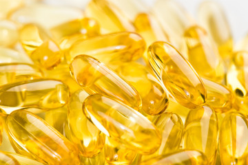 shiny yellow vitamin e fish oil capsule on white background - 105620697