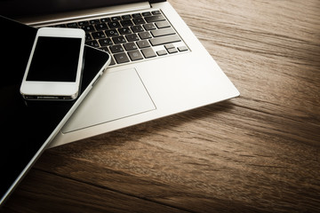 keyboard with phone and tablet pc on wooden desk