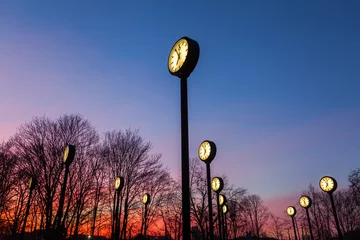 Bahnhofsuhren in einem Park in Düsseldorf nach Sonnenuntergang © Christian Müller