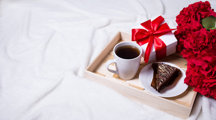 valentine's day concept - breakfast with cake, tea and little gi