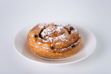 sweet bun with raisins over white