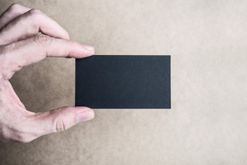 Black business card Mockup in man's hand
