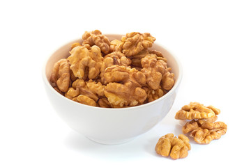 Walnuts in white bowl isolated on white background