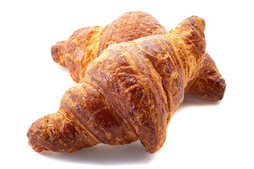 Two fresh croissants isolated on white background