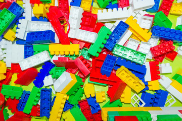 Many colorful plastic toy blocks, red, blue, white, yellow