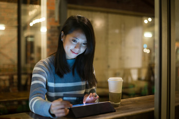 Woman using tablet pc for booking hotel for next trip