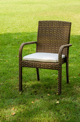 Rattan chair with cushion in the garden