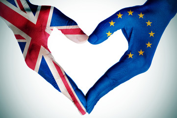 hands patterned with the British and the European flag forming a