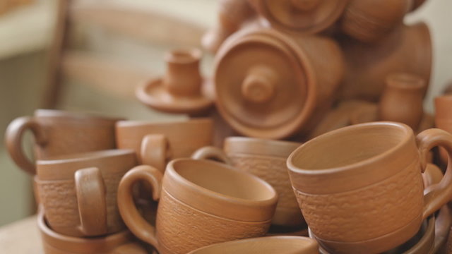 Rustic handmade ceramic clay brown terracotta cups souvenirs at the pottery studio. RAW video record.