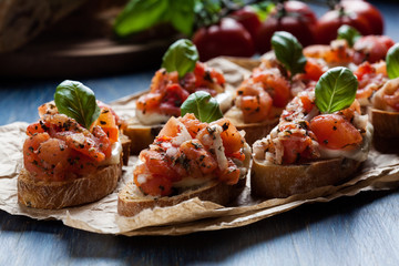Italian bruschetta with roasted tomatoes, mozzarella cheese and