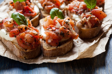 Italian bruschetta with roasted tomatoes, mozzarella cheese and