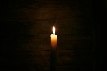 candle on old wooden background