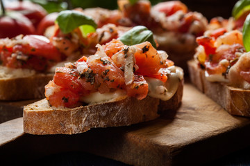 Italian bruschetta with roasted tomatoes, mozzarella cheese and