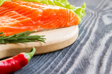 Fresh raw salmon fillet on cutting board.