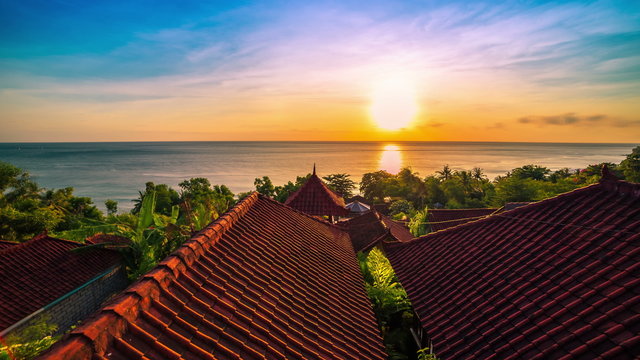 4K Timelapse. Sunrise overlooking the roofs of the bungalows and the Indian Ocean. 15 July 2015, Bali, Indonesia