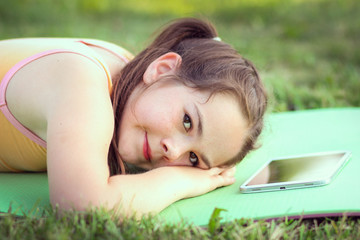 handsome  girl  work with pad outdoors