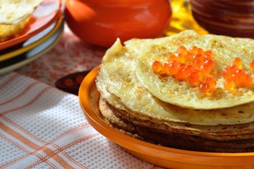 Pancakes with red caviar. Pile of pancakes on a plate