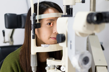 Woman doing eye test in optical clinic