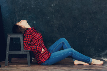 beautiful girl sitting near the chair in the Studio