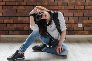 smiling girl taking photo with dslr camera in funny positions