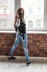 smiling girl taking photo with dslr camera in funny positions