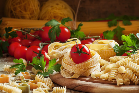 Dry italian pasta in assortment, cherry tomatoes, parsley, selec