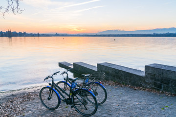 Fototapeta premium A pair of bicycles in the lake at sunset