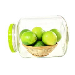 fresh lemon lime citrus fruit in bamboo basket in bottle