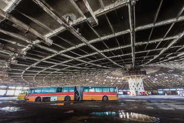 Colored buses in abandoned bus depot