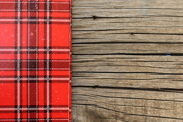 Plaid pattern on wooden background - copy space