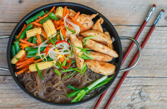 Glass noodles with chicken, green beans, carrots, corn, soya sprouts and greens. Oriental cuisine

