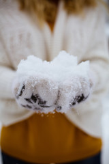 woman throwing snow in the air on winter holidays