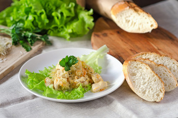 Chicken fillet with cheese, served with fresh greens and French baguette