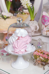 Dessert table for a party. Ombre cake, cupcakes, sweetness and flowers