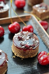 sweet chocolate desserts with frosting and cherries.