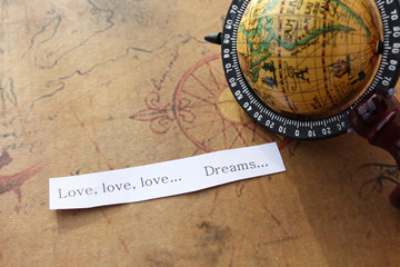 Love and dream message and globe in the background - travel concept