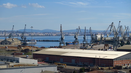 Fototapeta na wymiar Port cranes handling containers at Thessaloniki port, Greece.